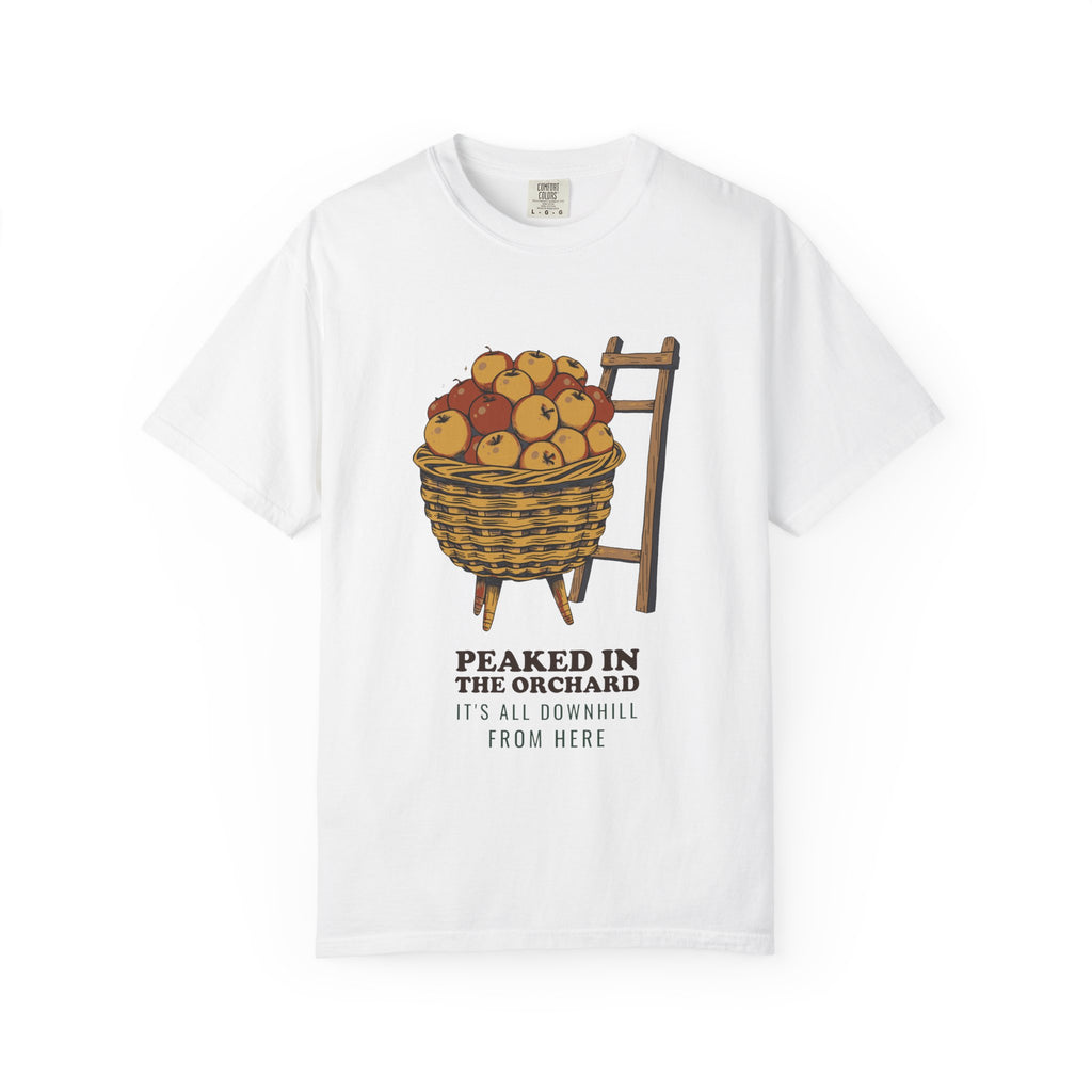 Peaked in the Orchard tee in White — Comfort Colors unisex T-shirt with a basket of apples beside an orchard ladder, with the words PEAKED IN THE ORCHARD IT'S ALL DOWNHILL FROM HERE printed on the front