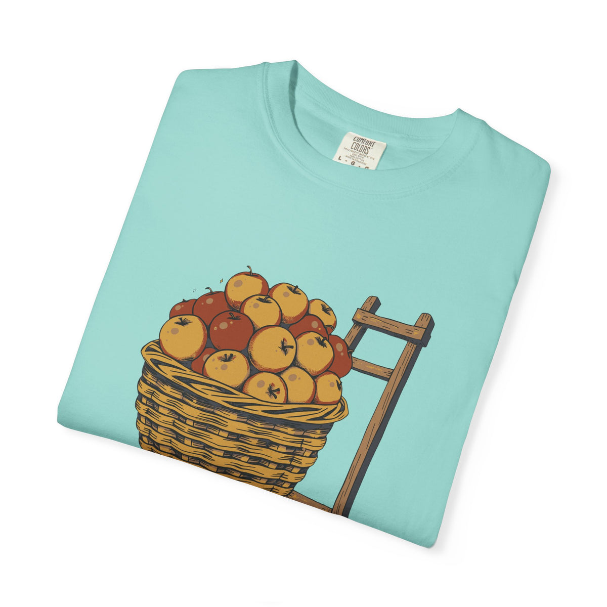 Peaked in the Orchard tee in Chalky Mint, folded — close view of the apple basket print