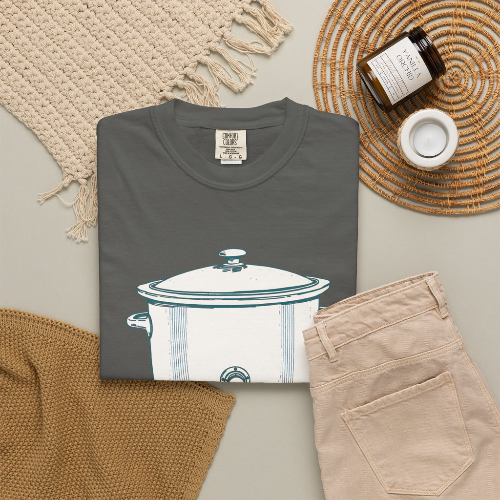 I Have Feelings I'm Processing Them Slowly tee in Pepper grey, folded in a styled flat lay with a woven mat, candle and khaki shorts — slow cooker print on the front