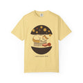 Lunch Break Read tee in Butter yellow — Comfort Colors unisex T-shirt with a cat asleep on a stack of books under a starry night dome, with the words LUNCH BREAK READ underneath printed on the front